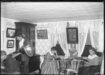 Family Relaxing In Their Living Room At Home by George French