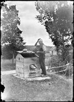 Man Standing At A Well Wiping His Head With A Cloth by George French