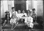 Group Of Eight Children Sitting On The Stoop Of A House by George French