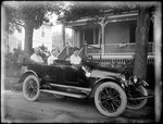 Three People Sitting In An 'open Air' 4 Door Reo Car by George French