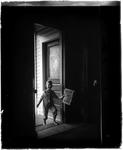 Young Boy In A Doorway Holding A Newspaper by George W. French