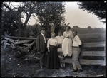 Empire Grove 04: Three Women and Two Men Standing by a Fence, East Poland, ca. 1911