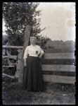 Empire Grove 05: Woman with Fern pinned to Shirt by Fence, East Poland, ca. 1911