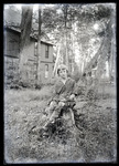 Empire Grove 16: Young Person Sitting on Stump, East Poland, ca. 1911 by Mary Irish