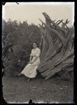 Empire Grove 25: Woman Sitting on Uprooted Tree Stump, East Poland, ca. 1911