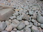 boulders on beach by Joseph Kelley