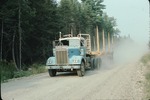 Logging truck on Stud Mill Road, eastern Maine by Woodrow B. Thompson