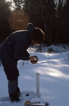 Craig Neil measuring water levels in winter.