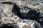 Clayters Beach - Granite-gabbro mixing. by Robert G. Marvinney