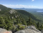 View from the summit of Tumbledown Mountain with Webb Lake and Mount Blue in the background.